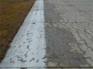Overview photo of a PCC slab with a noticable pattern of spalled cracks spread over the entire surface area of the slab.