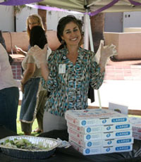 Sonya hands out pizza